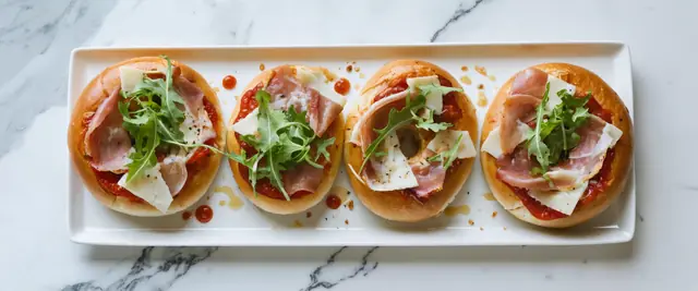 Pizza Bagels with Prosciutto and Arugula