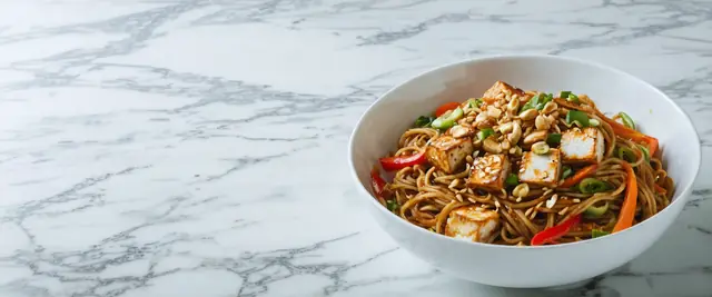Szechuan Tofu and Brown Rice Noodle Bowl with Spicy Peanut Sauce
